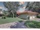 Charming home exterior with manicured lawn, a brick driveway, and a two-car garage at 5039 Kestral Park Dr # 67, Sarasota, FL 34231