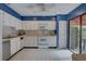 Bright kitchen with white cabinets, tile flooring, and modern appliances at 5039 Kestral Park Dr # 67, Sarasota, FL 34231