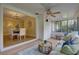 Inviting sunroom with tiled flooring, comfortable seating, and views into the dining area at 5039 Kestral Park Dr # 67, Sarasota, FL 34231