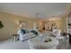 Bright and airy living room features plush seating and an open layout to the dining area, great for entertaining at 5039 Kestral Park Dr # 67, Sarasota, FL 34231