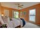 Comfortable main bedroom with a ceiling fan, neutral carpet, and access to the backyard at 5039 Kestral Park Dr # 67, Sarasota, FL 34231