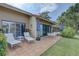 Spacious backyard patio with outdoor lounge chairs and sun umbrellas for relaxing at 5039 Kestral Park Dr # 67, Sarasota, FL 34231