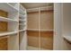 Spacious walk-in closet featuring custom shelving and ample storage space for organized living at 5039 Kestral Park Dr # 67, Sarasota, FL 34231