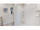 Bright bathroom showcasing a tiled shower with built-in shelves and stylish towel arrangement at 5042 Rocky Coast Pl, Palmetto, FL 34221