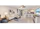 Open-plan living room featuring a seamless flow to the kitchen and stylish modern furnishings at 5042 Rocky Coast Pl, Palmetto, FL 34221