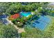 Aerial view of a community pool, tennis court, and surrounding trees at 5386 Creekside Trl, Sarasota, FL 34243