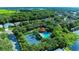 Aerial shot featuring community pool, tennis court, and surrounding neighborhood at 5386 Creekside Trl, Sarasota, FL 34243