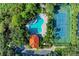 Aerial view showcasing community pool, tennis court, and lush landscaping at 5386 Creekside Trl, Sarasota, FL 34243