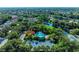 Aerial view showcasing community pool, tennis court, and lake in surrounding neighborhood at 5386 Creekside Trl, Sarasota, FL 34243
