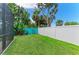 Well-maintained lawn featuring a combination of white and turquoise fencing at 5386 Creekside Trl, Sarasota, FL 34243