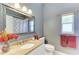 Charming bathroom featuring granite countertops and a decorative mirror at 5386 Creekside Trl, Sarasota, FL 34243