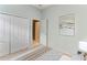 Clean and bright bedroom showcasing closet doors and neutral decor at 5386 Creekside Trl, Sarasota, FL 34243