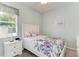 Bright bedroom features a ceiling fan and a window at 5386 Creekside Trl, Sarasota, FL 34243