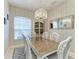 Dining room featuring a decorative chandelier, mirrored accent piece and seating for six at 5386 Creekside Trl, Sarasota, FL 34243