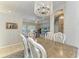 Dining area with chandelier, dining table and view of adjacent rooms that create a seamless flow in the home at 5386 Creekside Trl, Sarasota, FL 34243