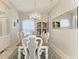 Elegant dining room with a chandelier, modern decor, and stylish dining set for sophisticated gatherings at 5386 Creekside Trl, Sarasota, FL 34243