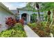 Inviting front entrance with decorative columns and vibrant landscaping at 5386 Creekside Trl, Sarasota, FL 34243