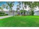 Charming single-story home featuring a manicured lawn and lush landscaping at 5386 Creekside Trl, Sarasota, FL 34243