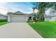 Charming single-story home featuring a manicured lawn and lush landscaping at 5386 Creekside Trl, Sarasota, FL 34243