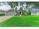 Charming single-story home featuring a manicured lawn and lush landscaping at 5386 Creekside Trl, Sarasota, FL 34243
