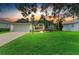 Charming single-story home featuring a manicured lawn and lush landscaping at 5386 Creekside Trl, Sarasota, FL 34243