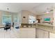 Kitchen showcasing granite countertops, stainless steel appliances, and seamless flow to the dining and living areas at 5386 Creekside Trl, Sarasota, FL 34243