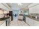 Modern kitchen with stainless steel appliances, granite countertops, and ample cabinet space for culinary enthusiasts at 5386 Creekside Trl, Sarasota, FL 34243
