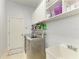 Functional laundry room with modern washer and dryer and plenty of storage space at 5386 Creekside Trl, Sarasota, FL 34243