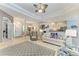 Bright living room featuring a decorative ceiling, plush sofa, and an open layout to the dining and kitchen areas at 5386 Creekside Trl, Sarasota, FL 34243