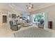 Spacious living room with tile flooring, tray ceiling, and sliding glass doors to patio at 5386 Creekside Trl, Sarasota, FL 34243