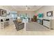 Spacious living room with tile flooring, tray ceiling, and sliding glass doors to patio at 5386 Creekside Trl, Sarasota, FL 34243