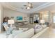 Living room showcasing neutral tones, comfortable seating, and access to other rooms, creating a welcoming atmosphere at 5386 Creekside Trl, Sarasota, FL 34243