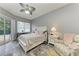 Serene main bedroom features a walkout to the pool, calming gray walls, and hardwood floors at 5386 Creekside Trl, Sarasota, FL 34243