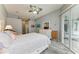 Relaxing bedroom offers an abundance of space, pool views, and walk-in closet access at 5386 Creekside Trl, Sarasota, FL 34243