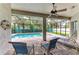 Covered patio with ceiling fan overlooking screened-in pool area with outdoor seating at 5386 Creekside Trl, Sarasota, FL 34243