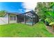 Screened-in pool area with well-maintained lawn and mature landscaping at 5386 Creekside Trl, Sarasota, FL 34243