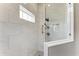 Elegant walk-in shower features marble walls, a frameless glass enclosure, and modern fixtures at 5386 Creekside Trl, Sarasota, FL 34243