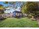 Landscaped backyard featuring a covered RV, fenced perimeter, and lush green lawn at 5403 2Nd W Ave, Bradenton, FL 34209