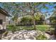 Lush backyard features a swing bench, mature trees, and a peaceful ambiance for relaxation at 5403 2Nd W Ave, Bradenton, FL 34209