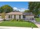 Charming single-story home with well-manicured lawn, a cozy front porch, and beautiful landscaping at 5403 2Nd W Ave, Bradenton, FL 34209