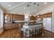 Kitchen featuring wooden cabinetry, a center island with seating, and pendant lighting with a modern design at 5403 2Nd W Ave, Bradenton, FL 34209