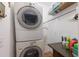 Bright laundry room with stacked washer and dryer and storage at 5403 2Nd W Ave, Bradenton, FL 34209