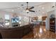 Spacious living area with a modern ceiling fan, TV, and open floor plan connecting to the kitchen with bar seating at 5403 2Nd W Ave, Bradenton, FL 34209