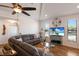 Bright living room featuring a vaulted ceiling, wood floors, ceiling fan, and a comfortable gray sectional sofa at 5403 2Nd W Ave, Bradenton, FL 34209