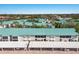 Aerial view showcasing the building, parking, and beautifully maintained surrounding landscape at 5623 Midnight Pass Rd # 615, Sarasota, FL 34242