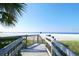 Inviting beach access stairs lead down to a pristine beach with soft, white sand at 5623 Midnight Pass Rd # 615, Sarasota, FL 34242