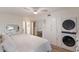 A clean bedroom with a laundry area, ceiling fan, and bright light at 5623 Midnight Pass Rd # 615, Sarasota, FL 34242
