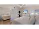 Another bedroom shot showing white furniture, modern fan, and mirrored closet at 5623 Midnight Pass Rd # 615, Sarasota, FL 34242