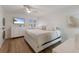 A cozy bedroom with white furniture, a ceiling fan, and a TV for entertainment at 5623 Midnight Pass Rd # 615, Sarasota, FL 34242