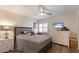 Comfortable bedroom featuring coastal-themed decor, light wood floors, and a ceiling fan at 5623 Midnight Pass Rd # 615, Sarasota, FL 34242